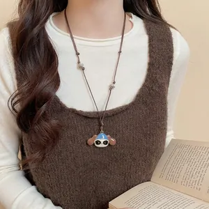 Cartoon dog and cat paw pendant necklace with brown leather cord on a model