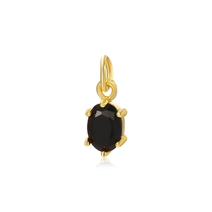 Close-up of a delicate gold-plated pendant featuring a black oval-shaped zircon stone