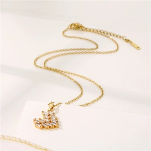 Elegant gold stainless steel necklace featuring a heart-shaped zircon pendant on white background