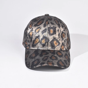 Detailed close-up of metallic leopard print texture on a stiff crown baseball cap
