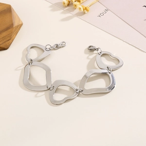 Detailed view of silver titanium steel bracelet with irregular geometric heart-shaped links