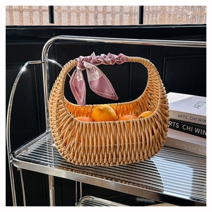Detail of hand-woven rattan basket bag with decorative floral scarf on the handle