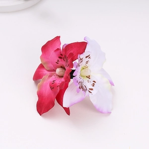 Detailed view of dual silk orchid hair clip featuring fuchsia and white gradient petals