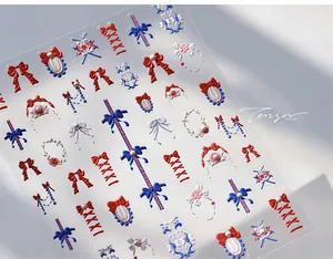 Macro view of 5D embossed nail stickers featuring ribbon bows and white lace textures