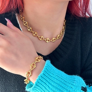 Gold geometric rhombus link necklace and bracelet set shown on female model