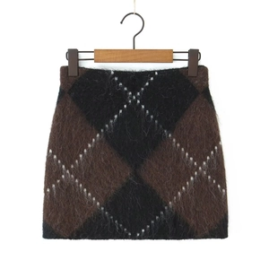 Detail of soft mohair-texture knit mini skirt with classic brown and black argyle pattern