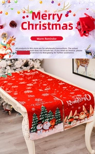 Close-up of red Christmas table runner featuring cartoon reindeer and snowman patterns