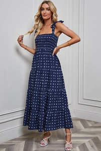 Detail view of navy blue maxi dress with white square print and ruched elastic bodice