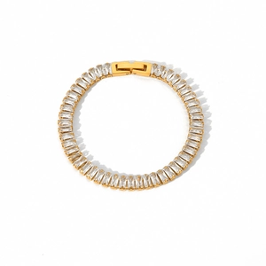 Macro shot of gold tennis bracelet featuring rectangular clear zircon stones and a secure clasp
