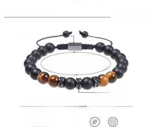 Detailed view of men's beaded bracelet with tiger eye, matte stone, and copper zircon accents