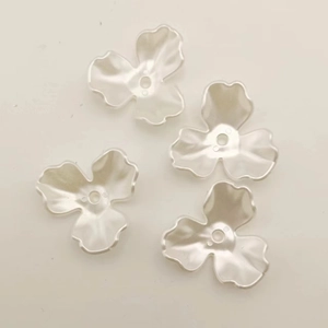 Macro detail of white pearl luster resin flower petals for DIY bridal jewelry making