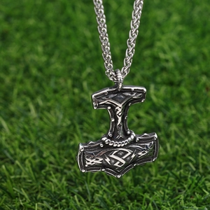 Detail of Viking Thor's hammer pendant with Nordic runes on a sturdy woven chain
