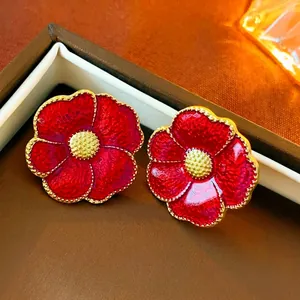Vintage red flower stud earrings with enamel petals and gold accents in a luxury box