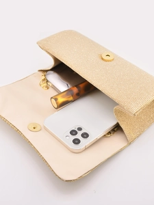 Internal view of golden pleated evening clutch bag showing storage space for phone