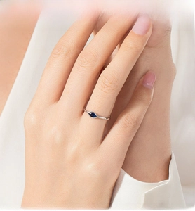 Detail of S925 silver ring featuring marquise-cut blue evil eye stone on finger