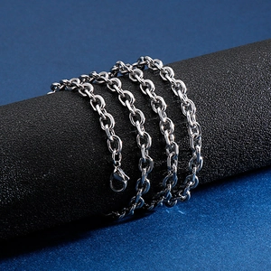 Minimalist silver stainless steel O-link chain necklace wrapped on a textured black stand