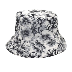 Close-up of black and white floral print texture and reinforced stitching on cotton bucket hat