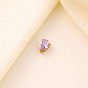 Macro view of pear-shaped purple zircon drop pendant in golden claw setting