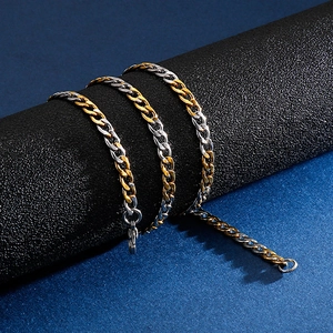 Macro shot of two-tone gold and silver cuban link chain with secure lobster clasp detail