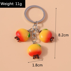 Macro shot of a pomegranate keychain showing the total length of 8.2cm and weight of 11g