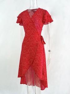 Detailed view of red polka dot wrap dress with ruffle sleeves and asymmetrical hemline
