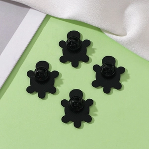 Set of four cute turtle pins with secure safety clasps on a light green background