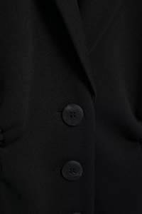 Detailed macro view of woven black fabric texture with two matching circular buttons