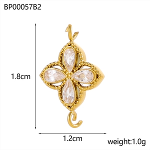 Detailed view of a gold clover charm with cubic zirconia showing 1.8cm length size