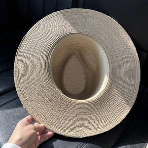 Handwoven raffia straw hat with a wide brim and classic sun protection panama style