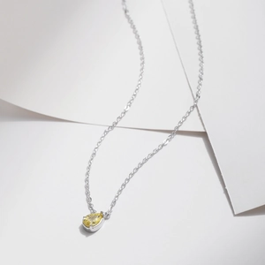 S925 sterling silver necklace with a yellow teardrop-shaped gemstone pendant on white background