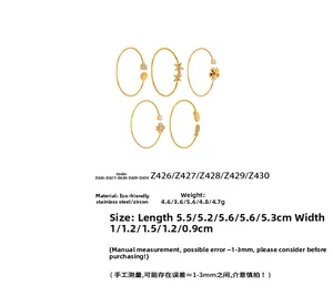 Detail of 18k gold plated stainless steel bracelets with flower and zircon charms set