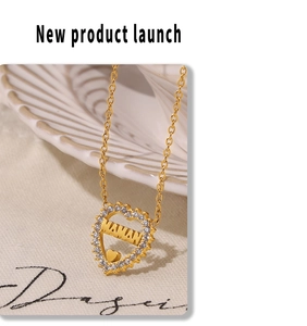 Detail of golden heart pendant with MAMAN engraving and pavé zircon stones
