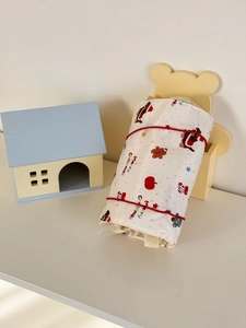 Detail of Christmas teddy bear storage bag with festive gingerbread man and santa prints
