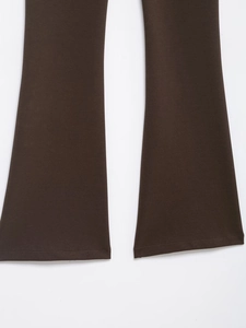 Detail of dark brown flare leg trousers with smooth texture and double-needle stitching