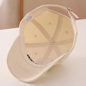 Detail view of cotton baseball cap interior with 100% cotton label and leopard print brim