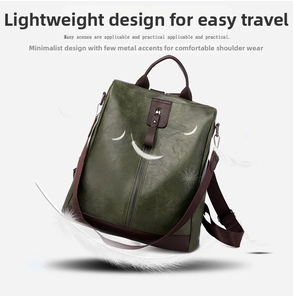 Detail of lightweight green PU leather backpack with brown straps on feather background