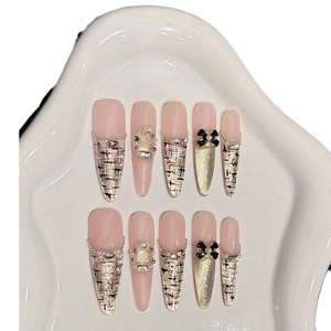 Pink almond press-on nails set with tweed pattern, 3D bows, pearls and gold shimmer