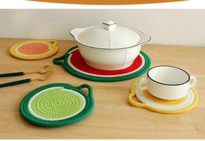 Detailed view of handmade cotton fruit placemats showing thick weave and heat protection