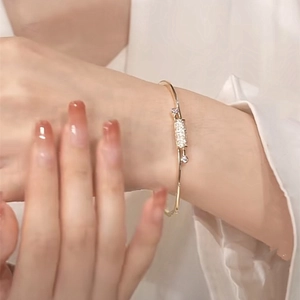 Exquisite gold-plated knot bracelet with micro-paved cubic zirconia on model wrist