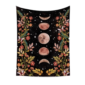 Detail of moon phase tapestry featuring floral accents and butterfly motifs on black