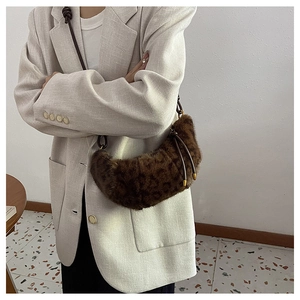 Détail du sac croissant en fausse fourrure léopard avec bandoulière en cuir