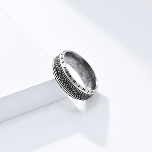 Macro detail of Nordic Viking runes and Celtic knot engraving on vintage silver ring