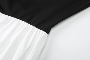 Detailed stitching of black and white color block dress with elegant waist pleats