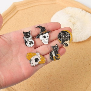 Five-piece Halloween gothic enamel pin set featuring black cats and skulls on a hand palm