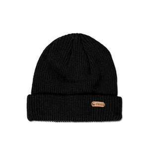 Close-up of black ribbed knit beanie featuring a brown leather patch with a deer logo