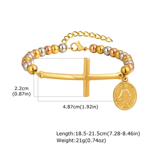 Detailed view of tri-color beaded bracelet with crucifix and religious medal charms