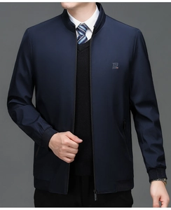 Detail of navy blue business jacket with stand collar and embroidered letter P on chest