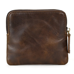 Close-up of brown genuine leather coin purse with zipper detail and smooth grain texture