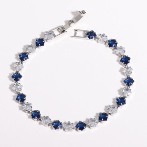 Detailed macro view of 18k gold plated copper beads with blue and clear zircon stones