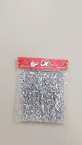 Close-up of clear Christmas icicle ornaments on stone background for tree decoration